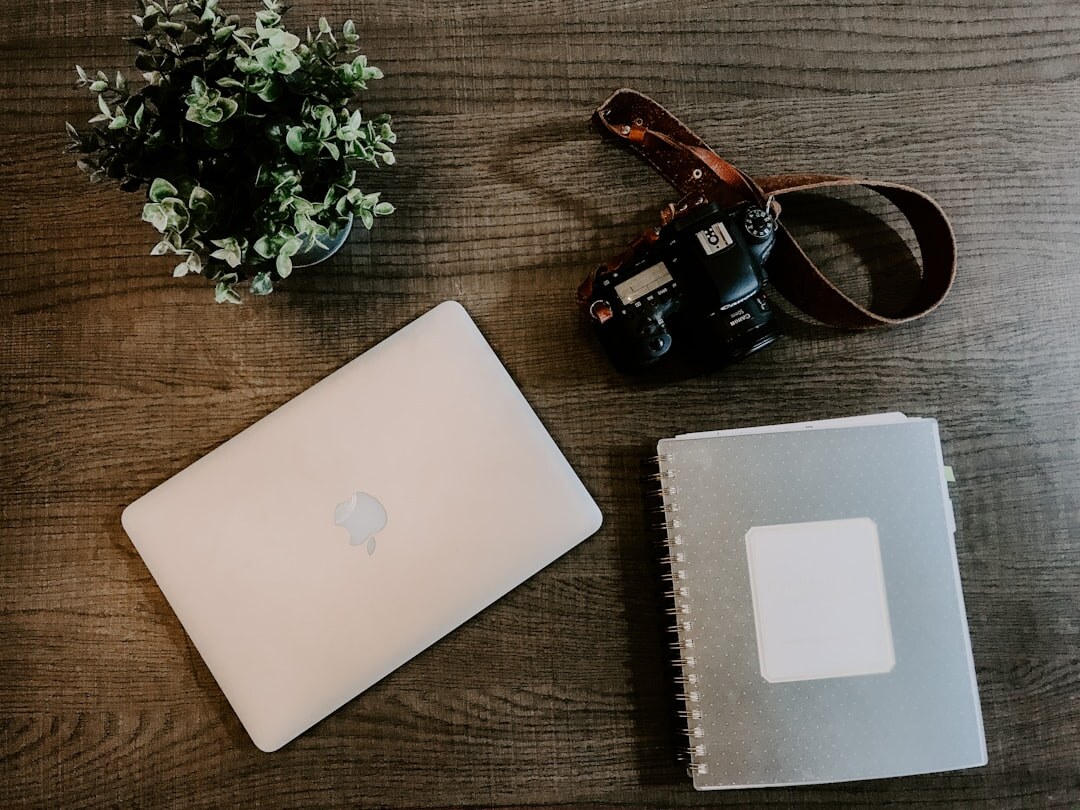 Editorial desk with a camera, notebook and coffee cup