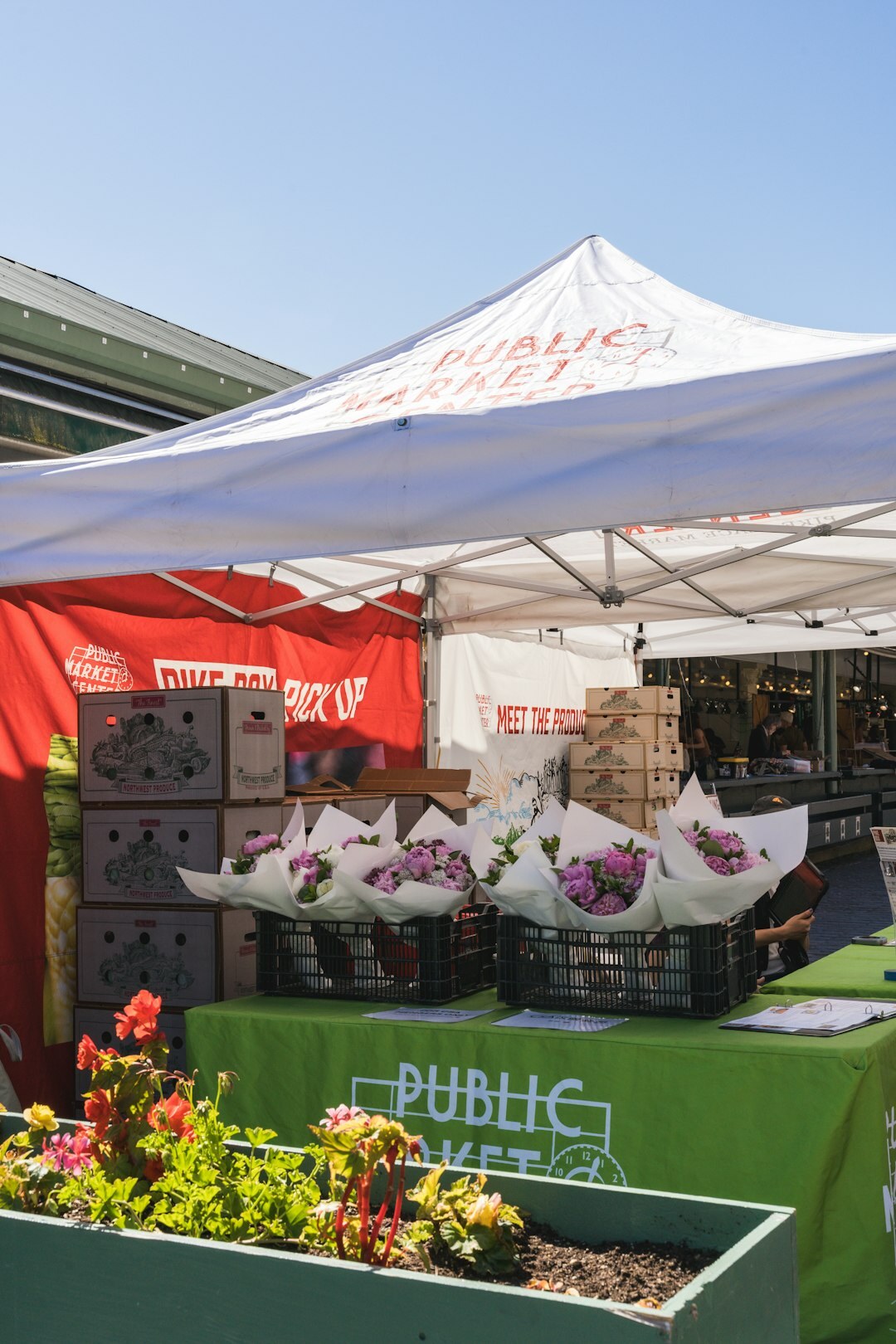 Fresh produce and flowers at a local outdoor market stall